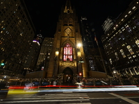 Traffic and pedestrians make their way along Broadway past Trinity Church in New York, N.Y., on December 12, 2024. (