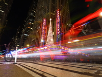 Car and foot traffic goes by Radio City Music Hall in New York, N.Y., on December 12, 2024. The photo is taken as a long exposure. (