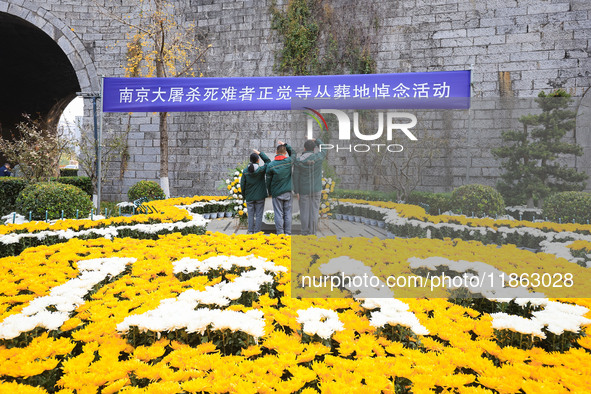 Students salute in front of the memorial for the victims of the Nanjing Massacre by Japanese invaders at Zhengjue Temple in Nanjing, Jiangsu...