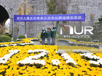 Students salute in front of the memorial for the victims of the Nanjing Massacre by Japanese invaders at Zhengjue Temple in Nanjing, Jiangsu...