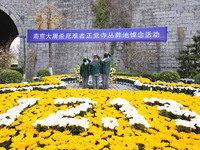 Students salute in front of the memorial for the victims of the Nanjing Massacre by Japanese invaders at Zhengjue Temple in Nanjing, Jiangsu...