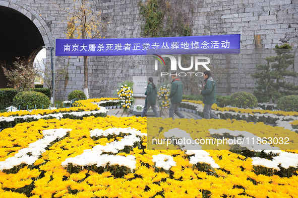 Students salute in front of the memorial for the victims of the Nanjing Massacre by Japanese invaders at Zhengjue Temple in Nanjing, Jiangsu...