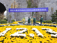 Students salute in front of the memorial for the victims of the Nanjing Massacre by Japanese invaders at Zhengjue Temple in Nanjing, Jiangsu...