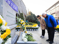 People pay their respects in front of the memorial monument for the victims of the Nanjing Massacre by Japanese invaders in Nanjing, East Ch...