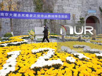 People present flowers to the memorial for the victims of the Nanjing Massacre by Japanese invaders at Zhengjue Temple in Nanjing, East Chin...