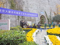 People present flowers to the memorial for the victims of the Nanjing Massacre by Japanese invaders at Zhengjue Temple in Nanjing, East Chin...