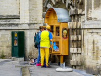 Two people engage with a public bookcase filled with lending books in Brussels, Belgium, on July 30, 2023. This free book exchange initiativ...