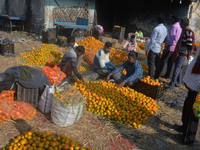 Indian workers sort oranges for packaging at a regulated market in Siliguri, India, on December 13, 2024. Every year, large numbers of orang...