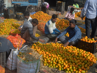 Indian workers sort oranges for packaging at a regulated market in Siliguri, India, on December 13, 2024. Every year, large numbers of orang...