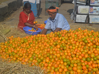 Indian workers sort oranges for packaging at a regulated market in Siliguri, India, on December 13, 2024. Every year, large numbers of orang...