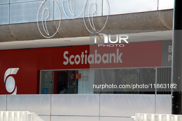 The logo of Canadian bank Scotiabank is on the facade of a bank branch at a shopping plaza in Mexico City, Mexico, on December 12, 2024. (Ph...