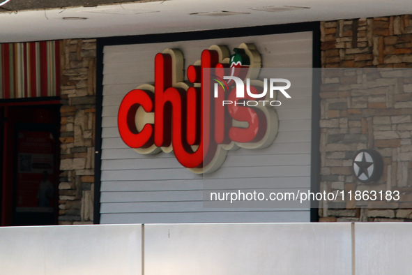 The logo of Chili's restaurant company appears on a facade at a shopping plaza in Mexico City, Mexico, on December 12, 2024. (Photo Illustra...