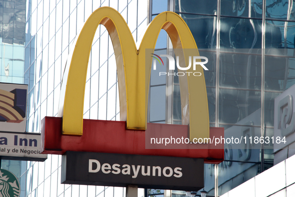 The logo of the fast food restaurant company McDonald's, which specializes in hamburgers, fries, and drinks, is seen outside a shopping plaz...