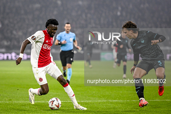 AFC Ajax Amsterdam forward Bertrand Traore and Lazio defender Luca Pellegrini play during the match between Ajax and Lazio at the Johan Crui...