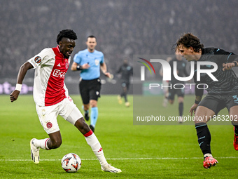 AFC Ajax Amsterdam forward Bertrand Traore and Lazio defender Luca Pellegrini play during the match between Ajax and Lazio at the Johan Crui...