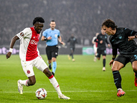 AFC Ajax Amsterdam forward Bertrand Traore and Lazio defender Luca Pellegrini play during the match between Ajax and Lazio at the Johan Crui...