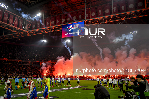 Fans of Ajax use fireworks during the match between Ajax and Lazio at the Johan Cruijff ArenA for the UEFA Europa League - League phase - Ma...