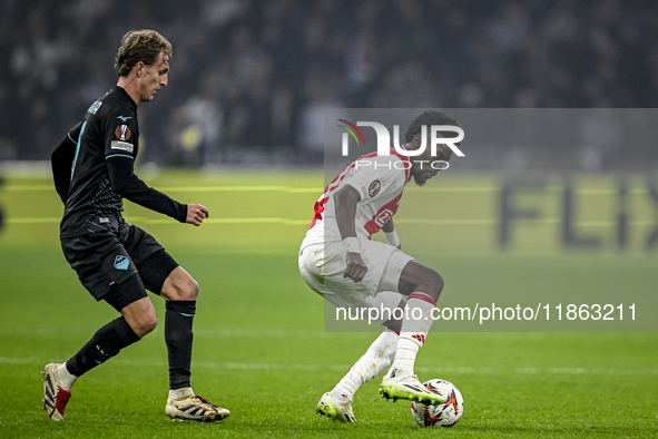 Lazio midfielder Nicolo Rovella and AFC Ajax Amsterdam forward Bertrand Traore play during the match between Ajax and Lazio at the Johan Cru...