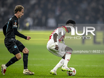 Lazio midfielder Nicolo Rovella and AFC Ajax Amsterdam forward Bertrand Traore play during the match between Ajax and Lazio at the Johan Cru...