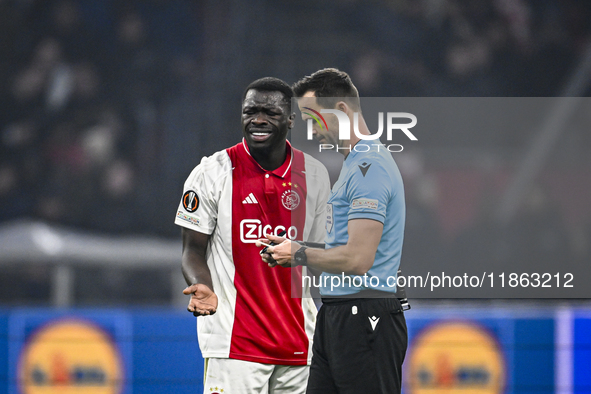 AFC Ajax Amsterdam forward Brian Brobbey and referee Ivan Kruzliak participate in the match between Ajax and Lazio at the Johan Cruijff Aren...