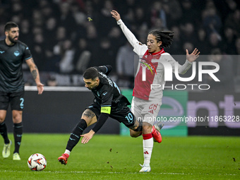 Lazio forward Mattia Zaccagni and AFC Ajax Amsterdam midfielder Kian Fitz-Jim play during the match between Ajax and Lazio at the Johan Crui...