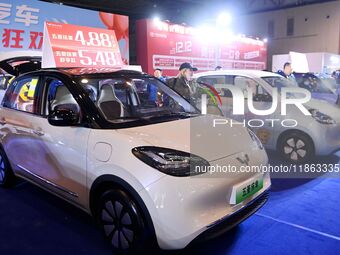 Exhibitors present subsidies and preferential promotion measures at the 16th Shandong International Auto Show 2024 in Qingdao, China, on Dec...