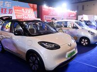 Exhibitors present subsidies and preferential promotion measures at the 16th Shandong International Auto Show 2024 in Qingdao, China, on Dec...