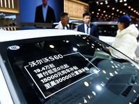 Exhibitors present subsidies and preferential promotion measures at the 16th Shandong International Auto Show 2024 in Qingdao, China, on Dec...