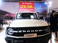 Exhibitors present subsidies and preferential promotion measures at the 16th Shandong International Auto Show 2024 in Qingdao, China, on Dec...