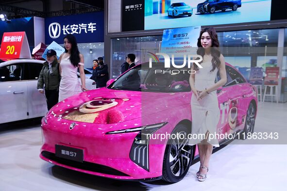 A female model promotes cars at the 16th Shandong International Auto Show 2024 in Qingdao, China, on December 13, 2024. 