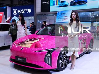 A female model promotes cars at the 16th Shandong International Auto Show 2024 in Qingdao, China, on December 13, 2024. (