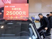 Exhibitors present subsidies and preferential promotion measures at the 16th Shandong International Auto Show 2024 in Qingdao, China, on Dec...