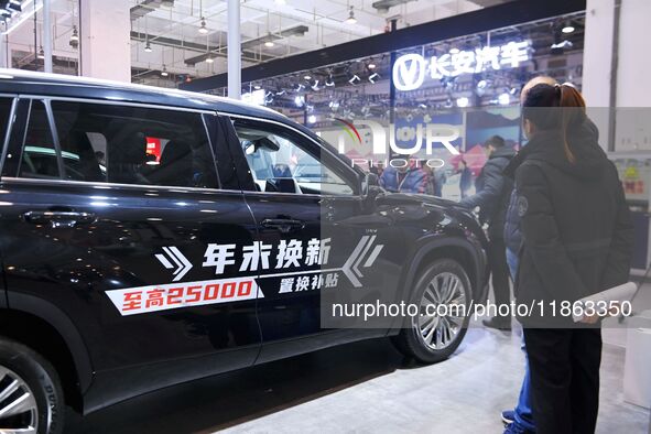 People view cars at the 16th Shandong International Auto Show in Qingdao, China, on December 13, 2024. 