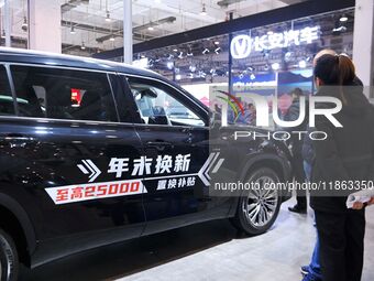 People view cars at the 16th Shandong International Auto Show in Qingdao, China, on December 13, 2024. (