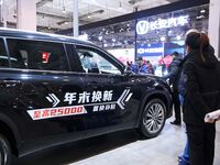 People view cars at the 16th Shandong International Auto Show in Qingdao, China, on December 13, 2024. (