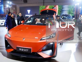 People view cars at the 16th Shandong International Auto Show in Qingdao, China, on December 13, 2024. (