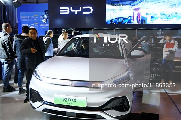 People view cars at the 16th Shandong International Auto Show in Qingdao, China, on December 13, 2024. 