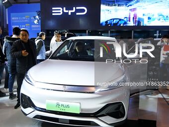 People view cars at the 16th Shandong International Auto Show in Qingdao, China, on December 13, 2024. (