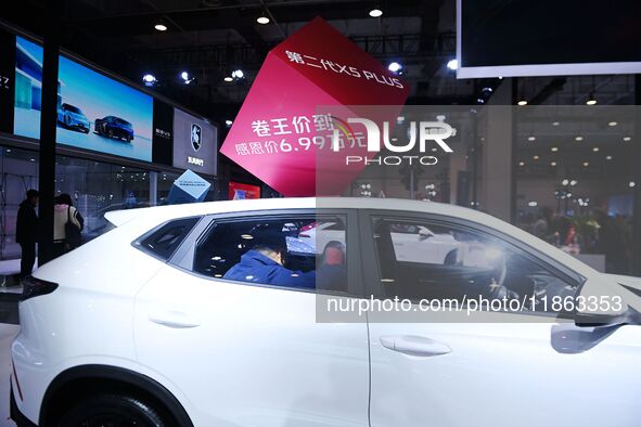 People view cars at the 16th Shandong International Auto Show in Qingdao, China, on December 13, 2024. 