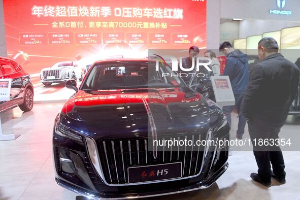 People view cars at the 16th Shandong International Auto Show in Qingdao, China, on December 13, 2024. 