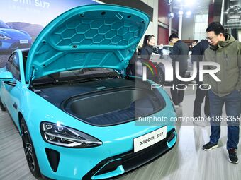 People view cars at the 16th Shandong International Auto Show in Qingdao, China, on December 13, 2024. (