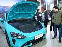 People view cars at the 16th Shandong International Auto Show in Qingdao, China, on December 13, 2024. (