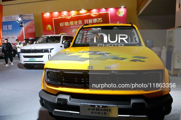 People view cars at the 16th Shandong International Auto Show in Qingdao, China, on December 13, 2024. 