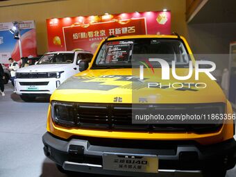 People view cars at the 16th Shandong International Auto Show in Qingdao, China, on December 13, 2024. (