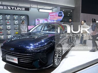 People view cars at the 16th Shandong International Auto Show in Qingdao, China, on December 13, 2024. (