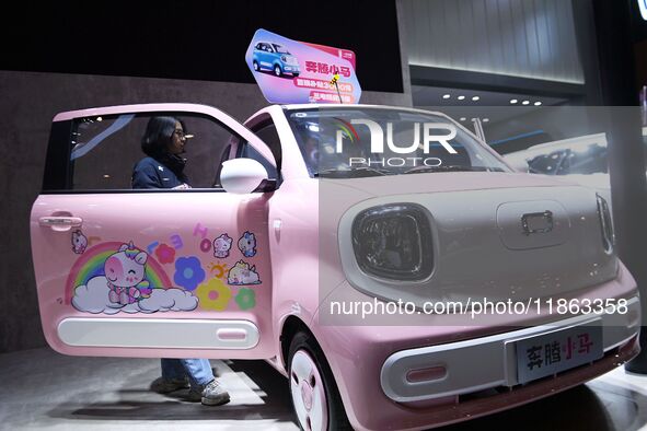 People view cars at the 16th Shandong International Auto Show in Qingdao, China, on December 13, 2024. 