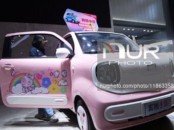 People view cars at the 16th Shandong International Auto Show in Qingdao, China, on December 13, 2024. (