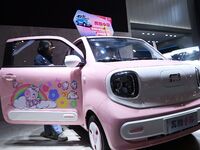 People view cars at the 16th Shandong International Auto Show in Qingdao, China, on December 13, 2024. (