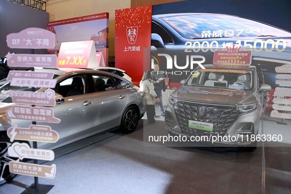 People view cars at the 16th Shandong International Auto Show in Qingdao, China, on December 13, 2024. 