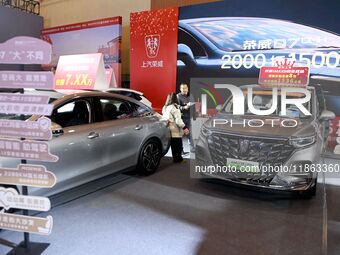 People view cars at the 16th Shandong International Auto Show in Qingdao, China, on December 13, 2024. (